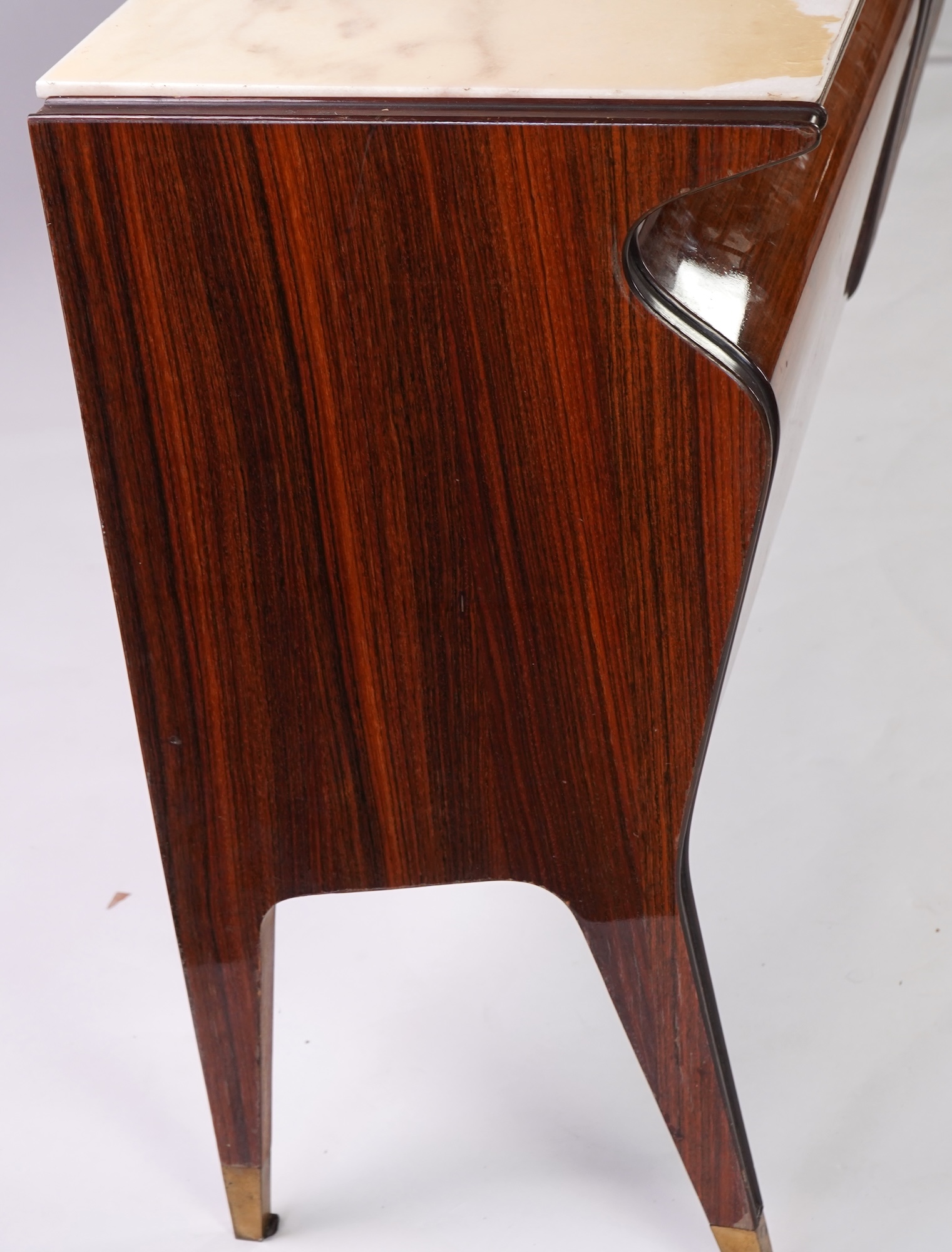 Osvaldo Borsani (Italian, 1911-1985) for Atelier Borsani Varedo: A large Indian rosewood and mahogany credenza, 276.5cm wide x 49cm deep x 94cm high